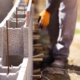 Image of a worker installing concrete masonry