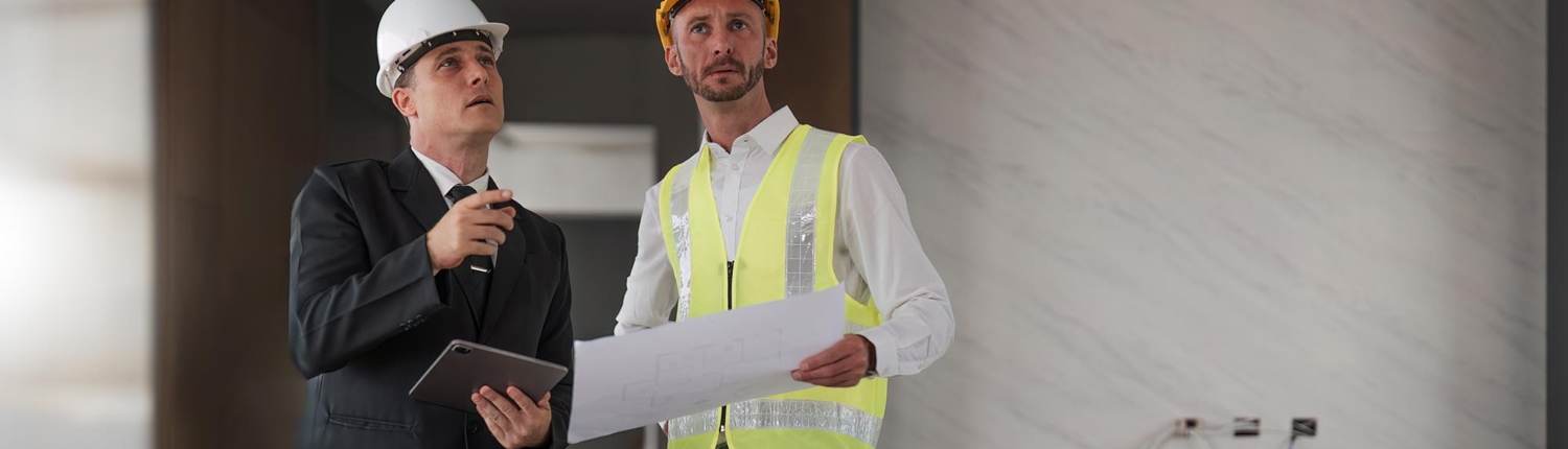 Side view of two construction professionals talking