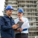 Two construction professionals looking at clipboard