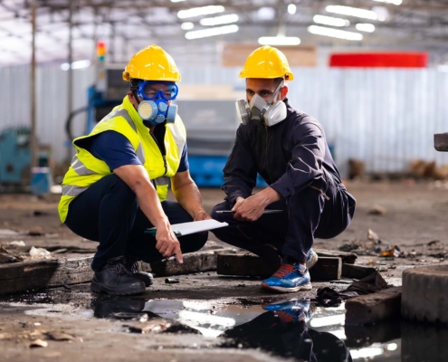Professionals inspecting damage in industrial property